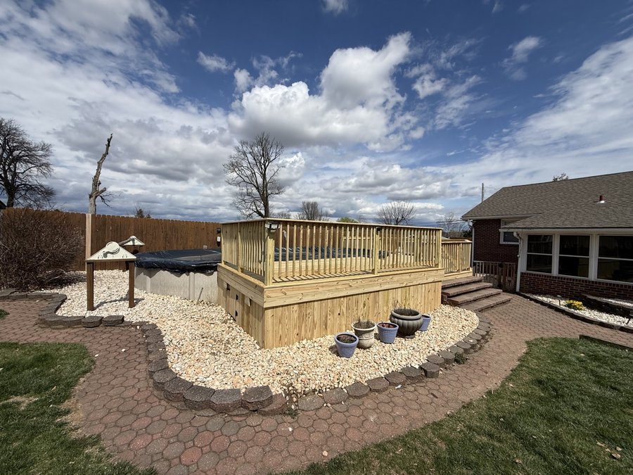 Natural wood pool deck with paver and gravel surround, built by E.B.R Deck Builder