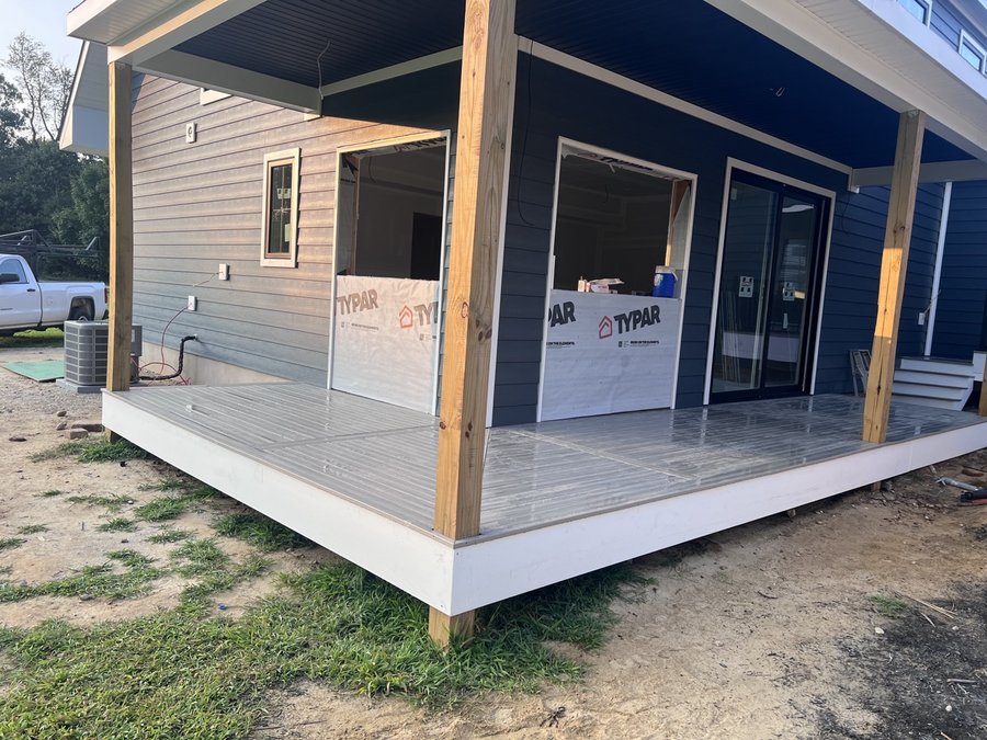 Covered porch deck with natural wood posts built by E.B.R Deck Builder
