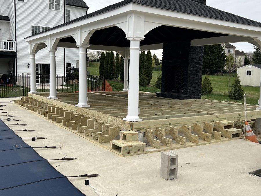 Large deck platform built under a pavilion with a stone fireplace