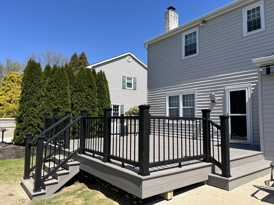 Low gray composite deck with black railing and wide entry steps